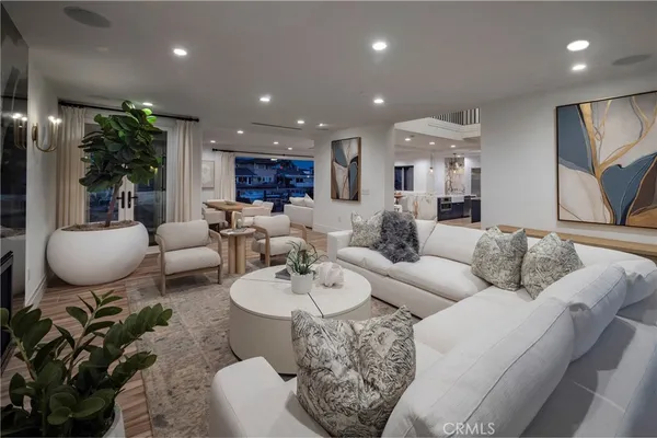 a living room with furniture and kitchen view