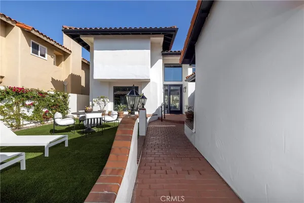 a view of a house with backyard sitting area and garden