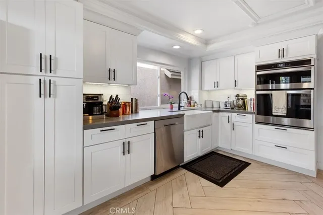 a kitchen with cabinets stainless steel appliances and a counter space