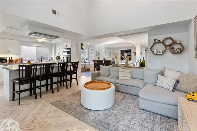 a living room with furniture a rug and a window