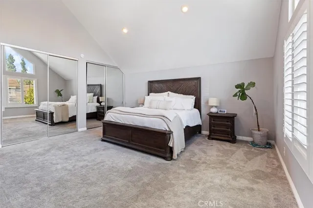 a bedroom with bed couch and window