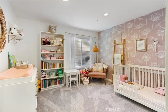 a bedroom with furniture and a book shelf