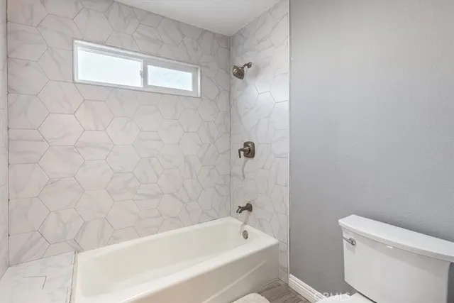 a bathroom with a bathtub and a toilet