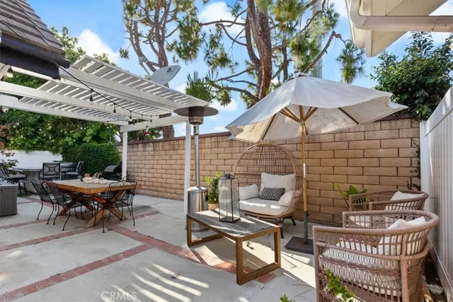 a view of a patio with a table and chairs under an umbrella