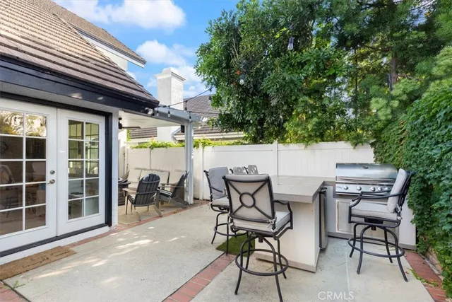 a view of a patio with table and chairs and potted plants