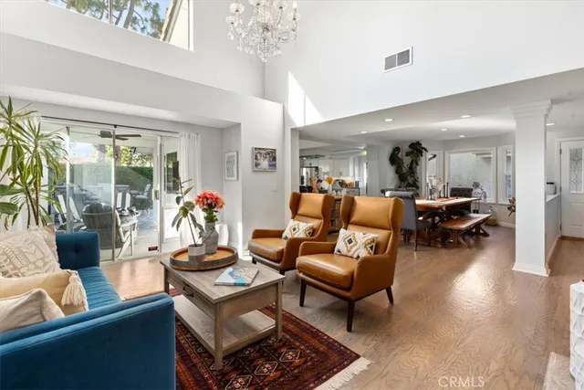 a living room with furniture and a chandelier