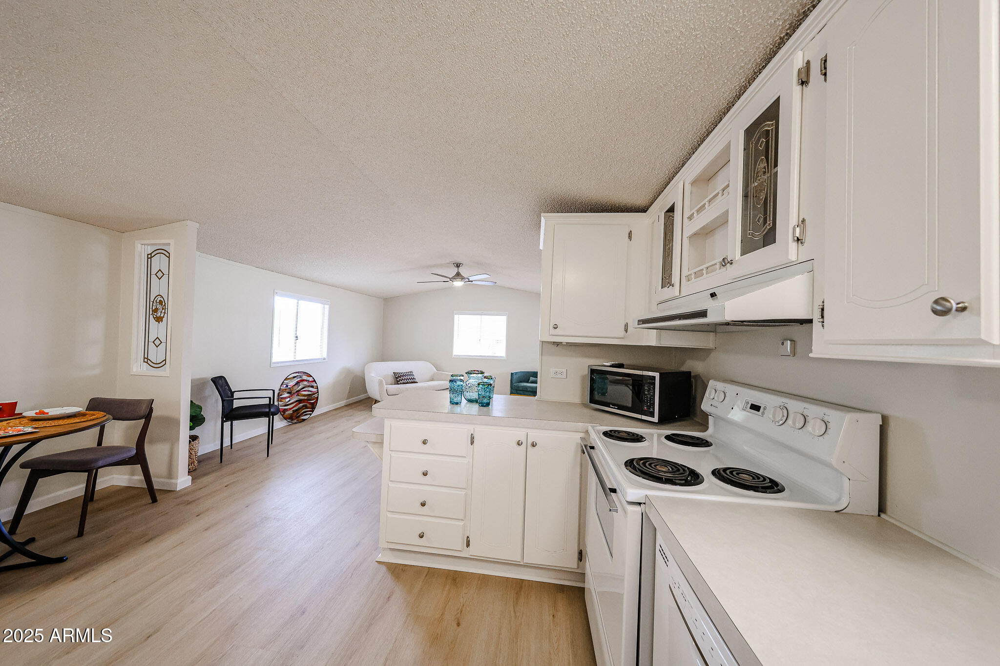 3901 East Pinnacle Peak Road, Unit 36 Phoenix, AZ 85050 - Photo 11 of 26 a kitchen with a stove a sink and a refrigerator
