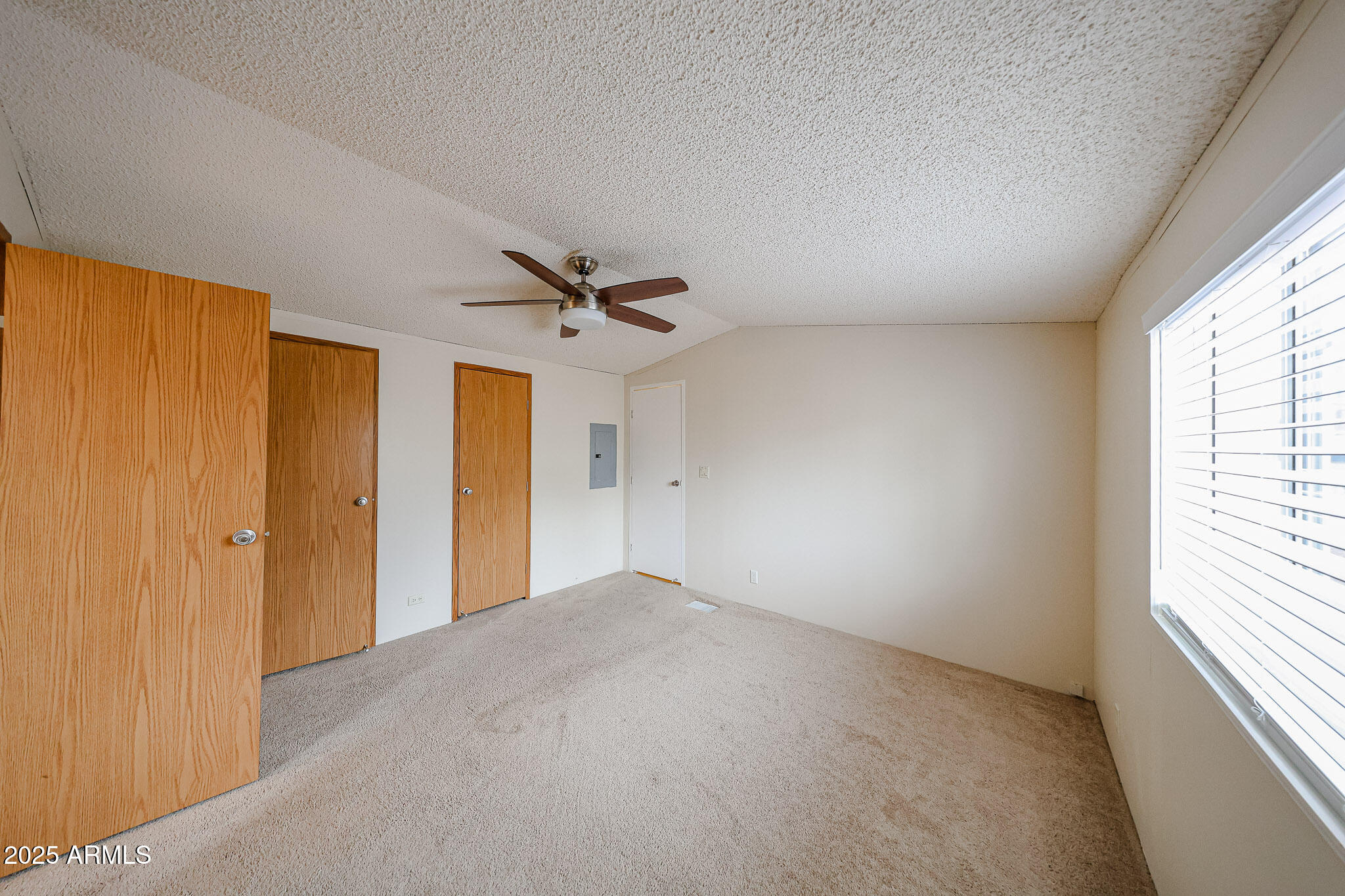 3901 East Pinnacle Peak Road, Unit 36 Phoenix, AZ 85050 - Photo 17 of 26 a view of a livingroom with a ceiling fan and window