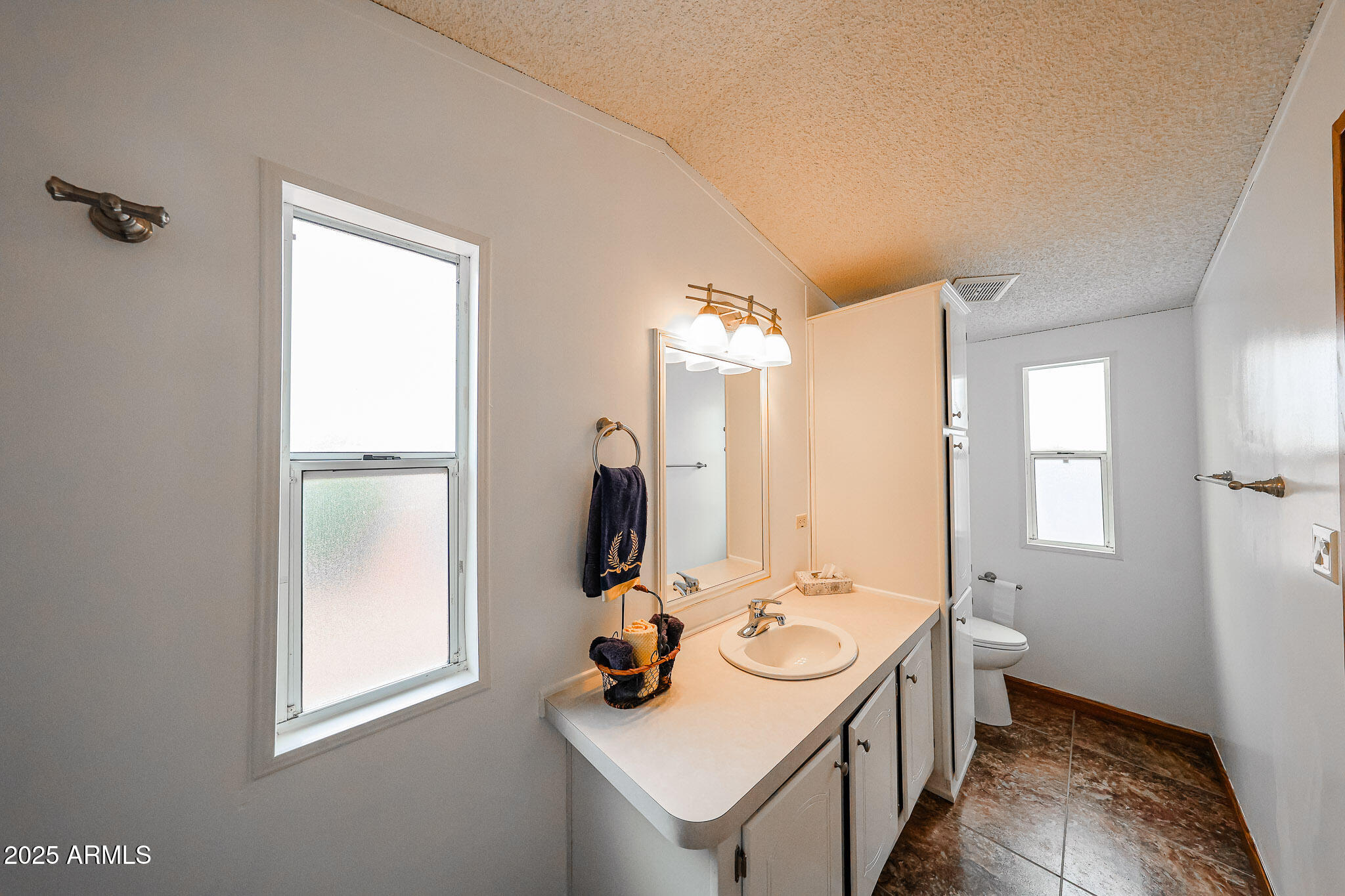 3901 East Pinnacle Peak Road, Unit 36 Phoenix, AZ 85050 - Photo 18 of 26 a bathroom with a sink and a mirror