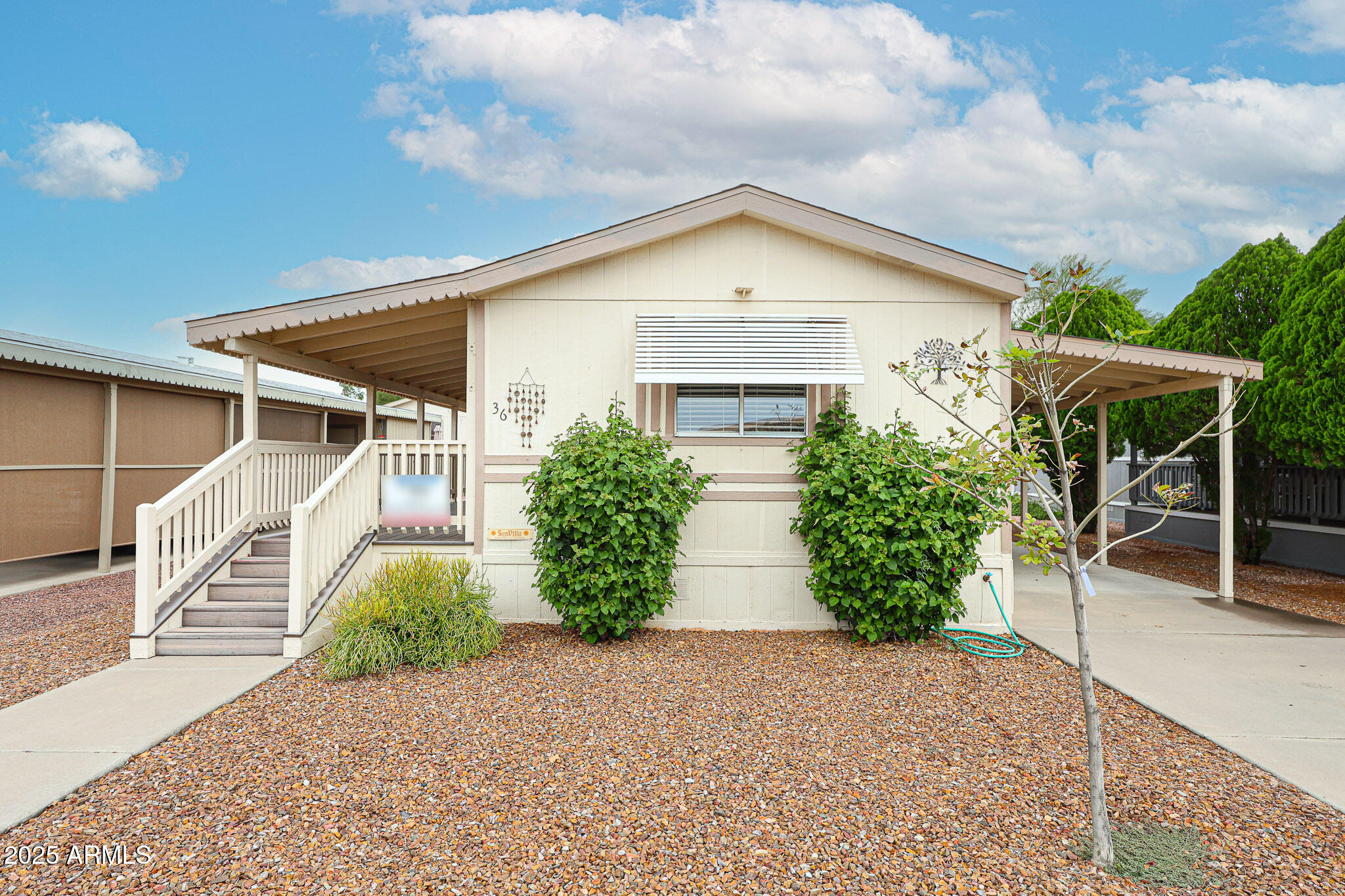3901 East Pinnacle Peak Road, Unit 36 Phoenix, AZ 85050 - Photo 2 of 26 a view of a house with a yard and plants