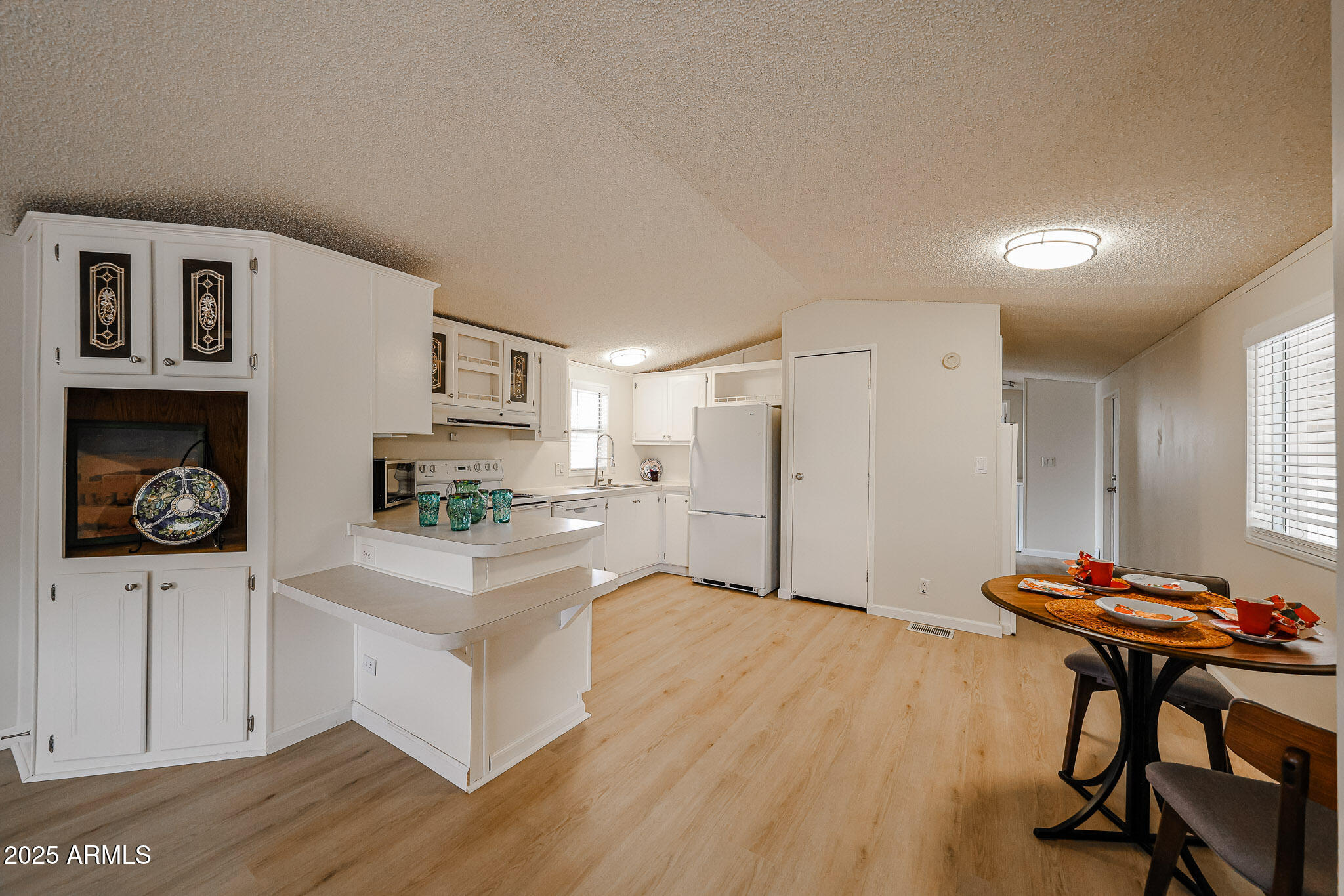 3901 East Pinnacle Peak Road, Unit 36 Phoenix, AZ 85050 - Photo 6 of 26 a kitchen with furniture and wooden floor