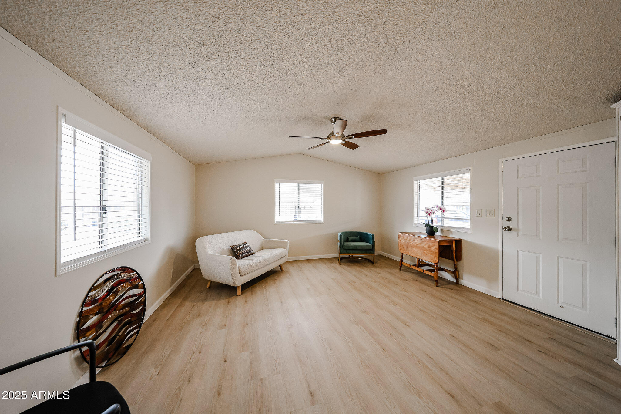 3901 East Pinnacle Peak Road, Unit 36 Phoenix, AZ 85050 - Photo 7 of 26 a living room with furniture and a wooden floor