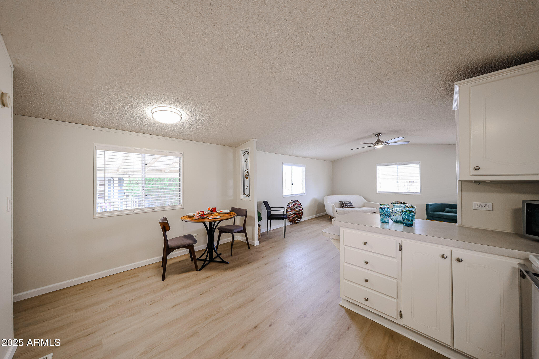 3901 East Pinnacle Peak Road, Unit 36 Phoenix, AZ 85050 - Photo 10 of 26 a living room with furniture and wooden floor