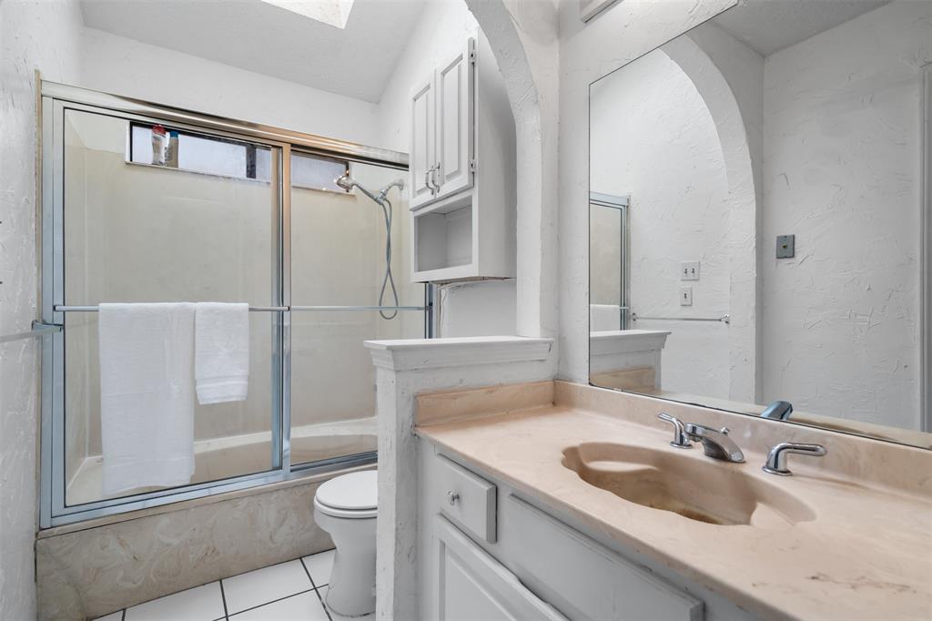 5590 Spring Valley Road, Unit H 203 Dallas, TX 75254 - Photo 15 of 27 Bathroom featuring a built-in vanity with an integrated sink and chrome fixtures