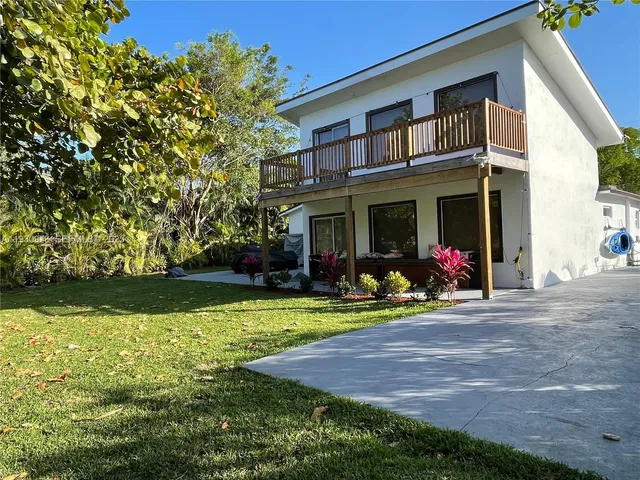 a front view of a house with swimming pool having outdoor seating