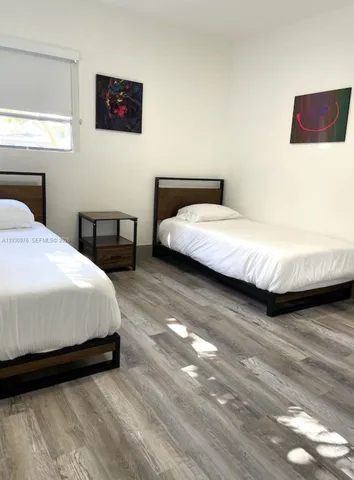 a bedroom with bed and a night stand