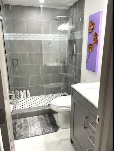 a bathroom with a shower and a toilet