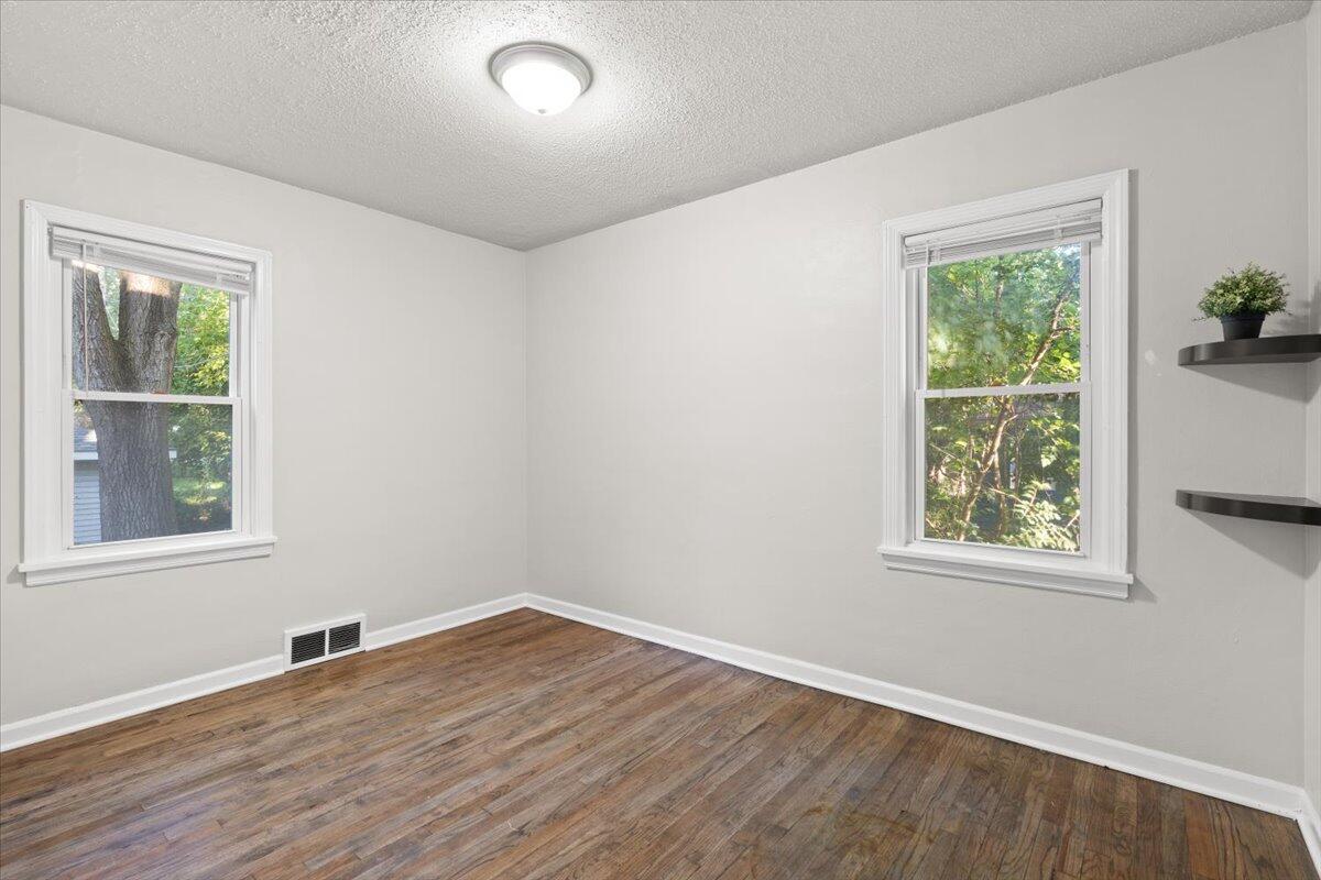 3642 Buchanan Street Gary, IN 46408 - Photo 11 of 25 an empty room with wooden floor and windows