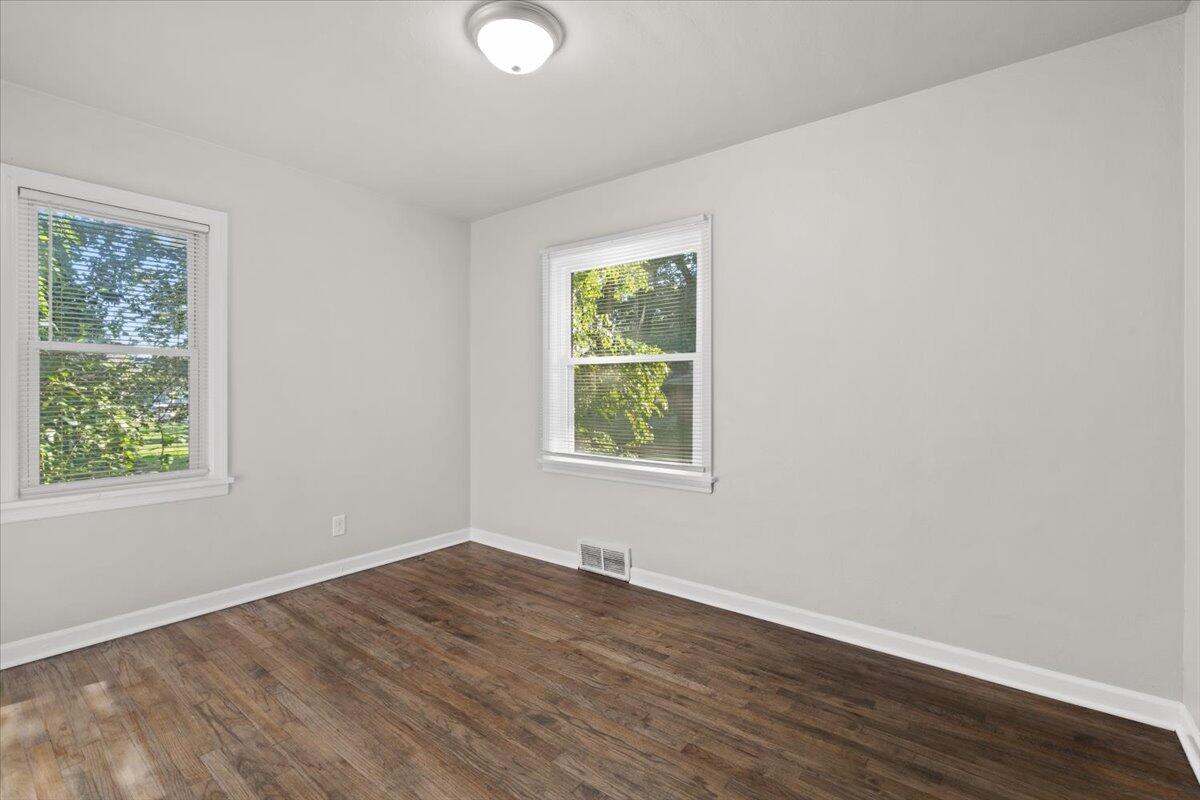 3642 Buchanan Street Gary, IN 46408 - Photo 13 of 25 an empty room with wooden floor and windows