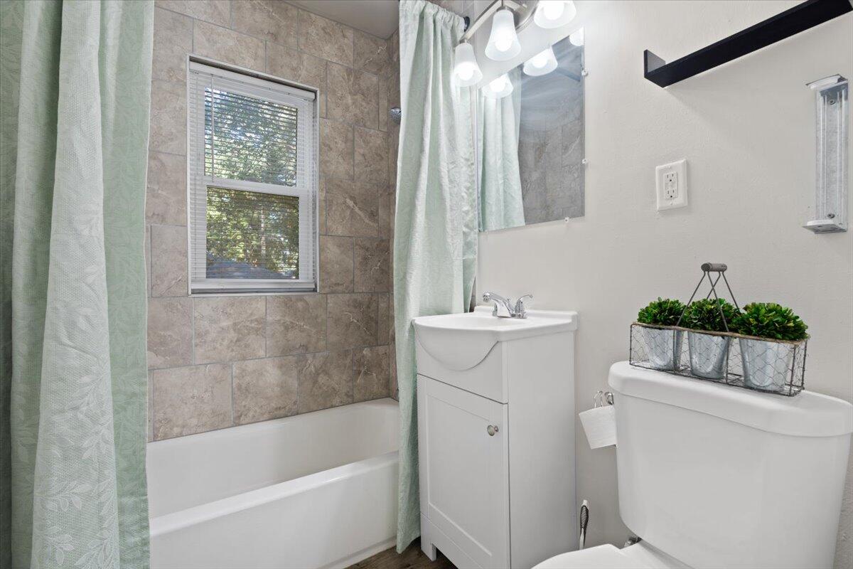 3642 Buchanan Street Gary, IN 46408 - Photo 14 of 25 a bathroom with a sink mirror vanity and toilet