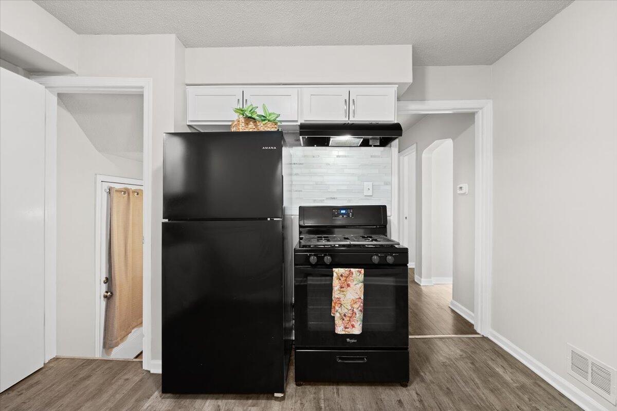 3642 Buchanan Street Gary, IN 46408 - Photo 10 of 25 a kitchen with a refrigerator and a stove