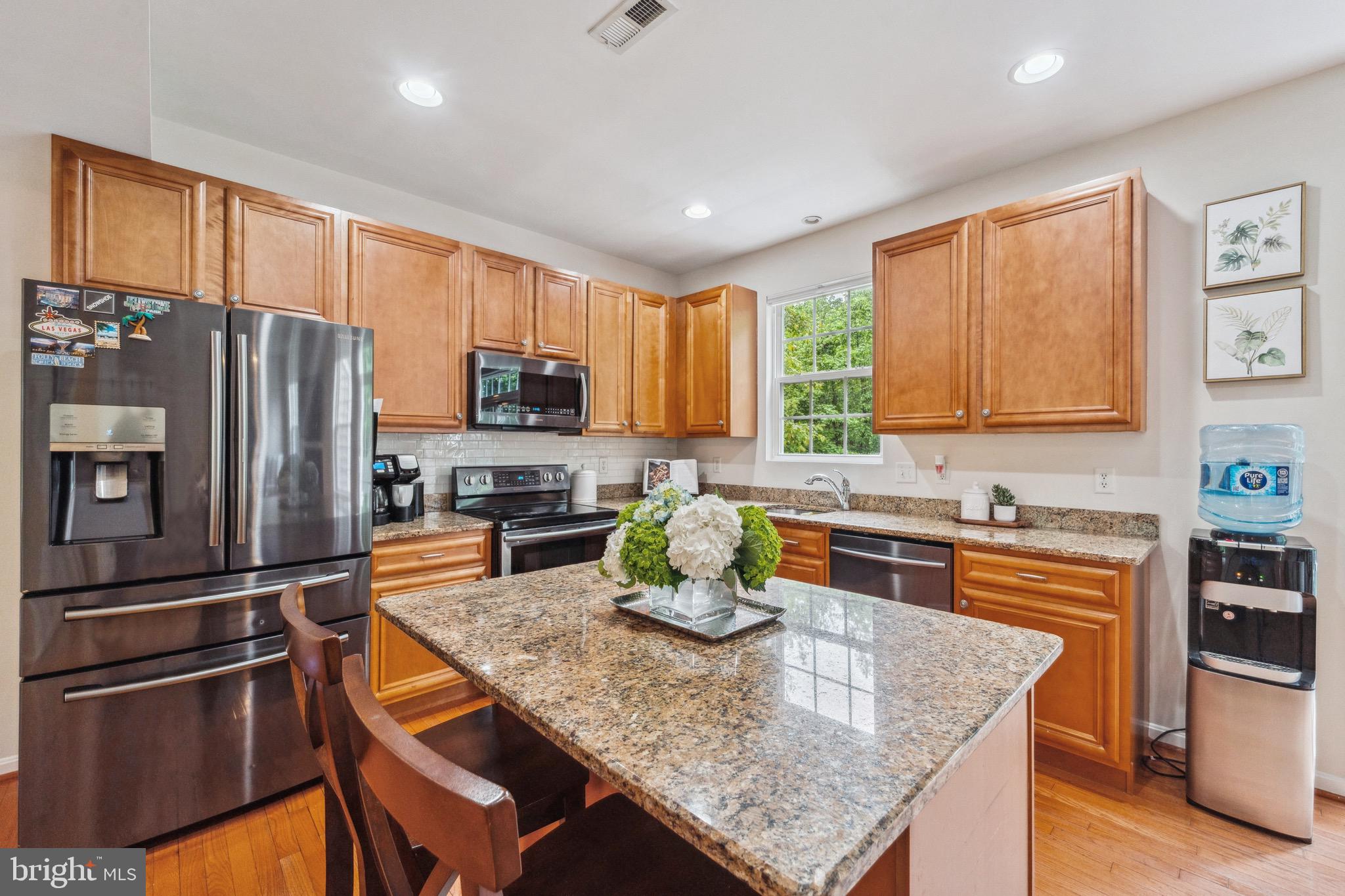 1407 James Way Edgewater, MD 21037 - Photo 17 of 30 a kitchen with stainless steel appliances granite countertop a refrigerator a stove top oven a sink and dishwasher
