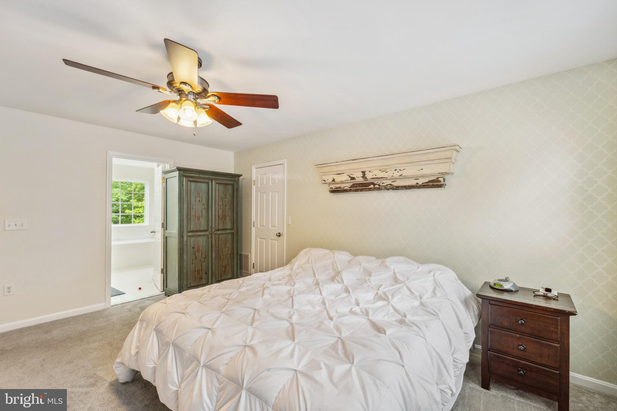 1407 James Way Edgewater, MD 21037 - Photo 20 of 30 a bedroom with a bed and a chandelier
