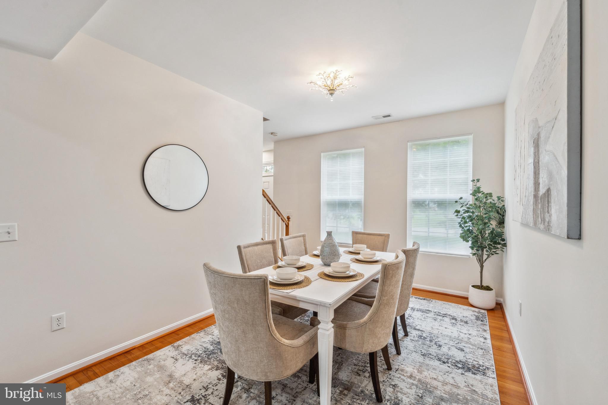 1407 James Way Edgewater, MD 21037 - Photo 9 of 30 a dining room with furniture a potted plant and a mirror