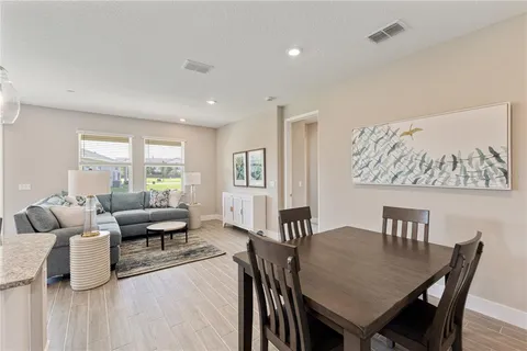 a view of a dining room with furniture and wooden floor