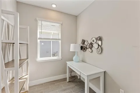 a view of a room with a window and wooden floor