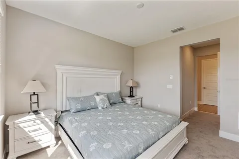 a bedroom with a bed and a lamp