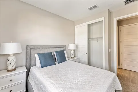 a bedroom with a bed and a night stand