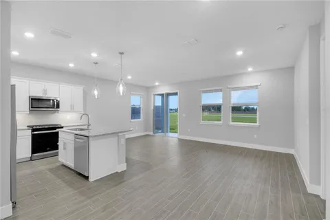 a view of kitchen with sink and microwave