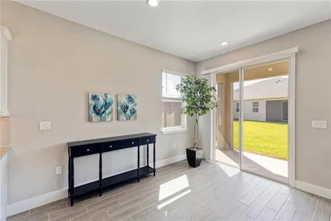a view of an empty room with a window and a swimming pool