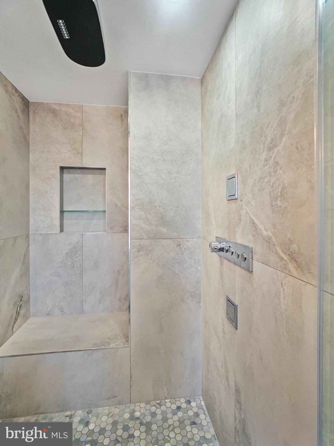 2228 13th Street Northwest, Unit 3 Washington, DC 20009 - Photo 23 of 44 Sleek, modern shower with elegant stone tiles.