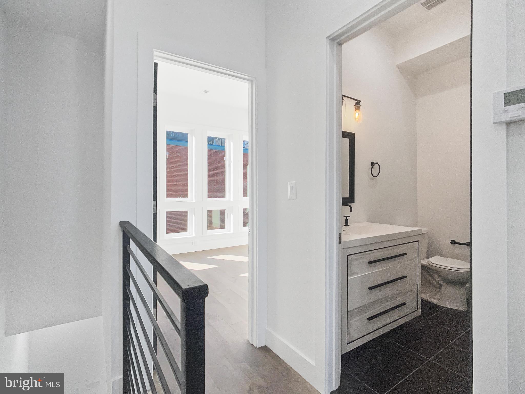 2228 13th Street Northwest, Unit 3 Washington, DC 20009 - Photo 27 of 44 Modern hallway with sleek bathroom access.