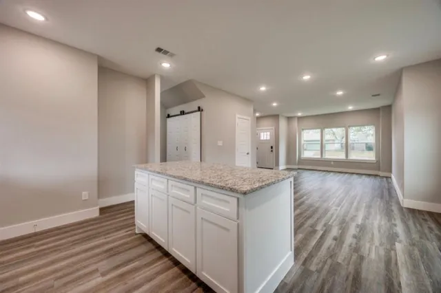 a bathroom with a granite countertop sink window and a mirror