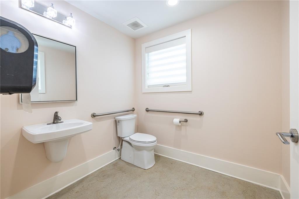 1651 Pryor Road Southwest Atlanta, GA 30315 - Photo 17 of 50 a bathroom with a toilet sink and mirror