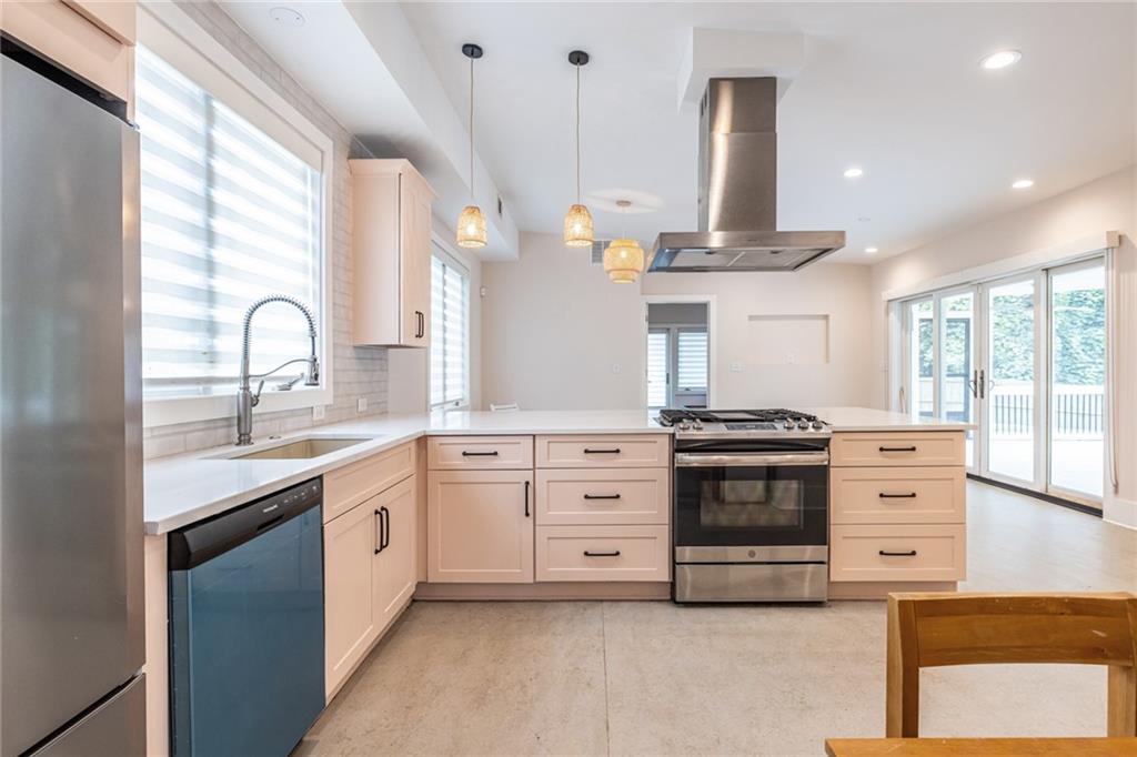 1651 Pryor Road Southwest Atlanta, GA 30315 - Photo 23 of 50 a kitchen with granite countertop a stove a sink and a window