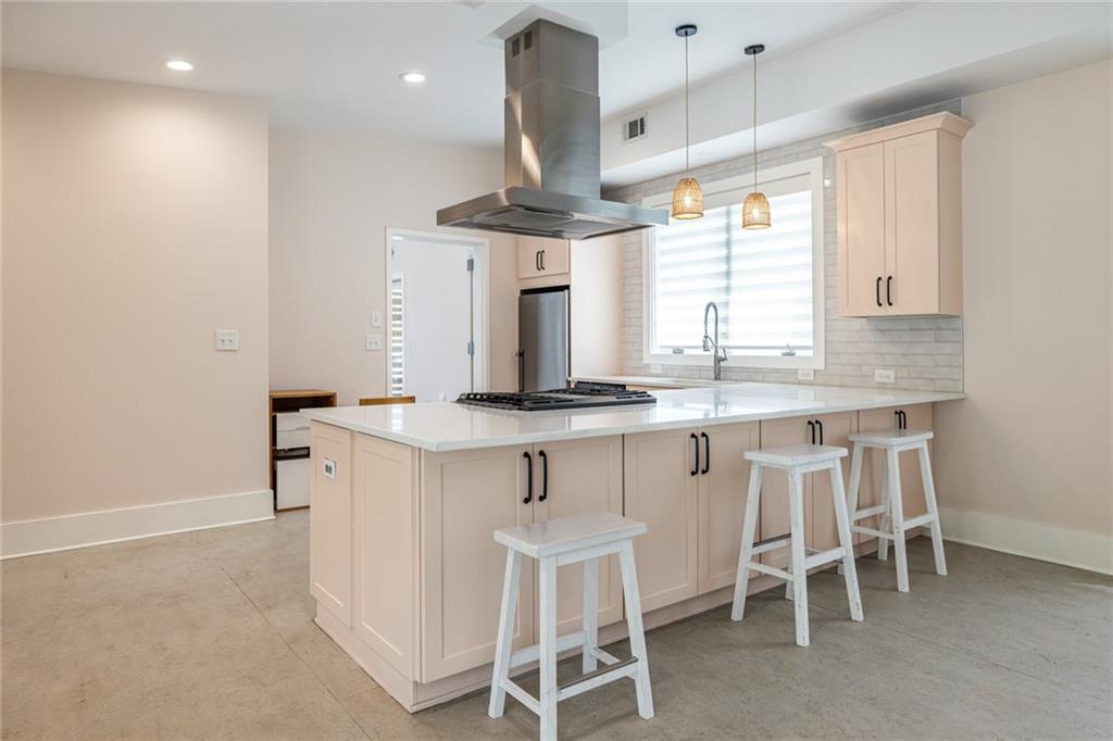 1651 Pryor Road Southwest Atlanta, GA 30315 - Photo 26 of 50 a kitchen with granite countertop white cabinets and chairs