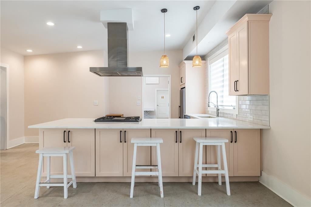 1651 Pryor Road Southwest Atlanta, GA 30315 - Photo 27 of 50 a kitchen with white cabinets and chairs