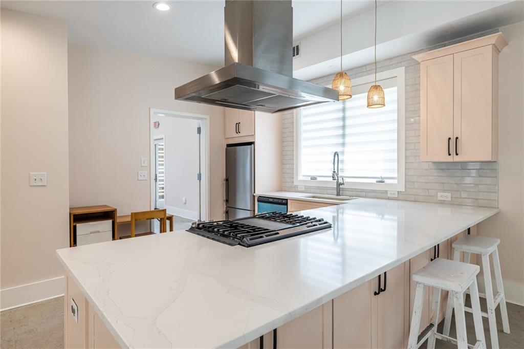 1651 Pryor Road Southwest Atlanta, GA 30315 - Photo 28 of 50 a kitchen with stainless steel appliances a sink a stove and white cabinets