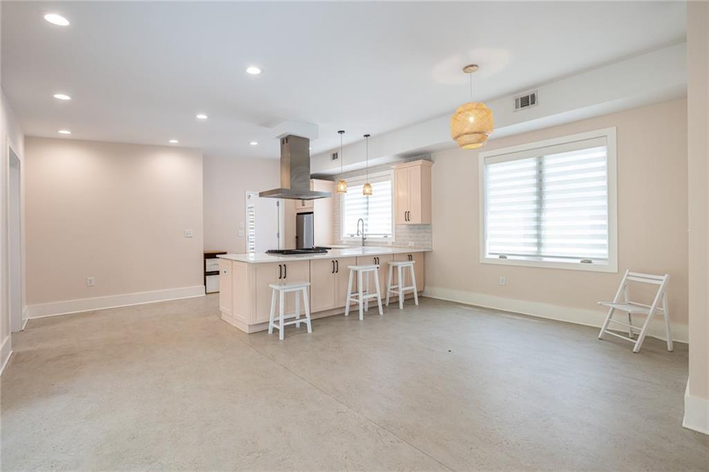 1651 Pryor Road Southwest Atlanta, GA 30315 - Photo 30 of 50 an empty room with windows and chairs