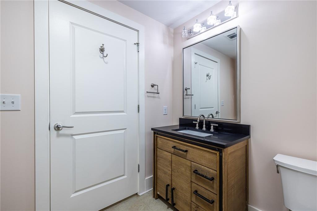 1651 Pryor Road Southwest Atlanta, GA 30315 - Photo 45 of 50 a bathroom with a sink a toilet and a mirror