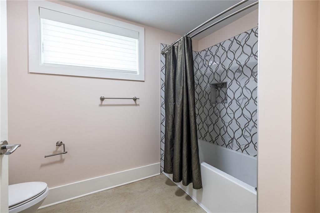 1651 Pryor Road Southwest Atlanta, GA 30315 - Photo 47 of 50 a bathroom with a bathtub and shower