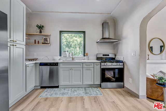 a kitchen with a sink stove and refrigerator