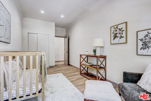 a bedroom with furniture and wooden floor