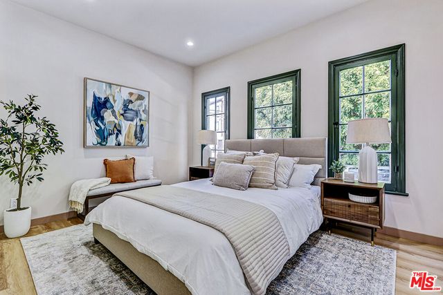 a bedroom with bed and a window