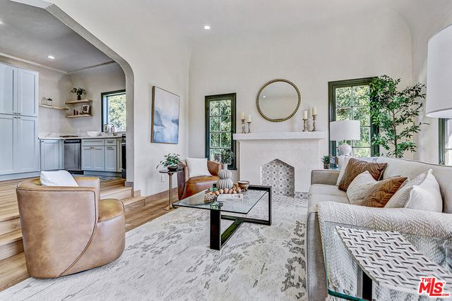 a living room with furniture a rug and a fireplace