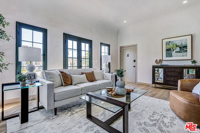a living room with furniture a fireplace and a table